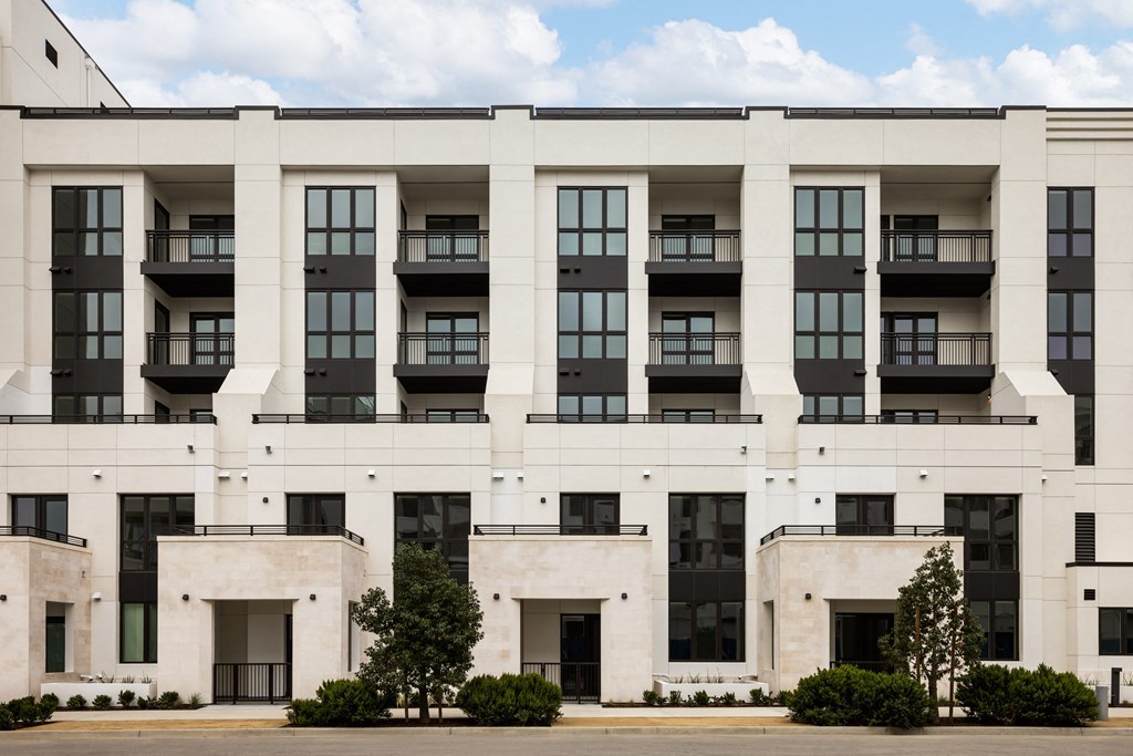 a large white building with trees in front of it