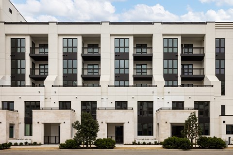 a large white building with trees in front of it