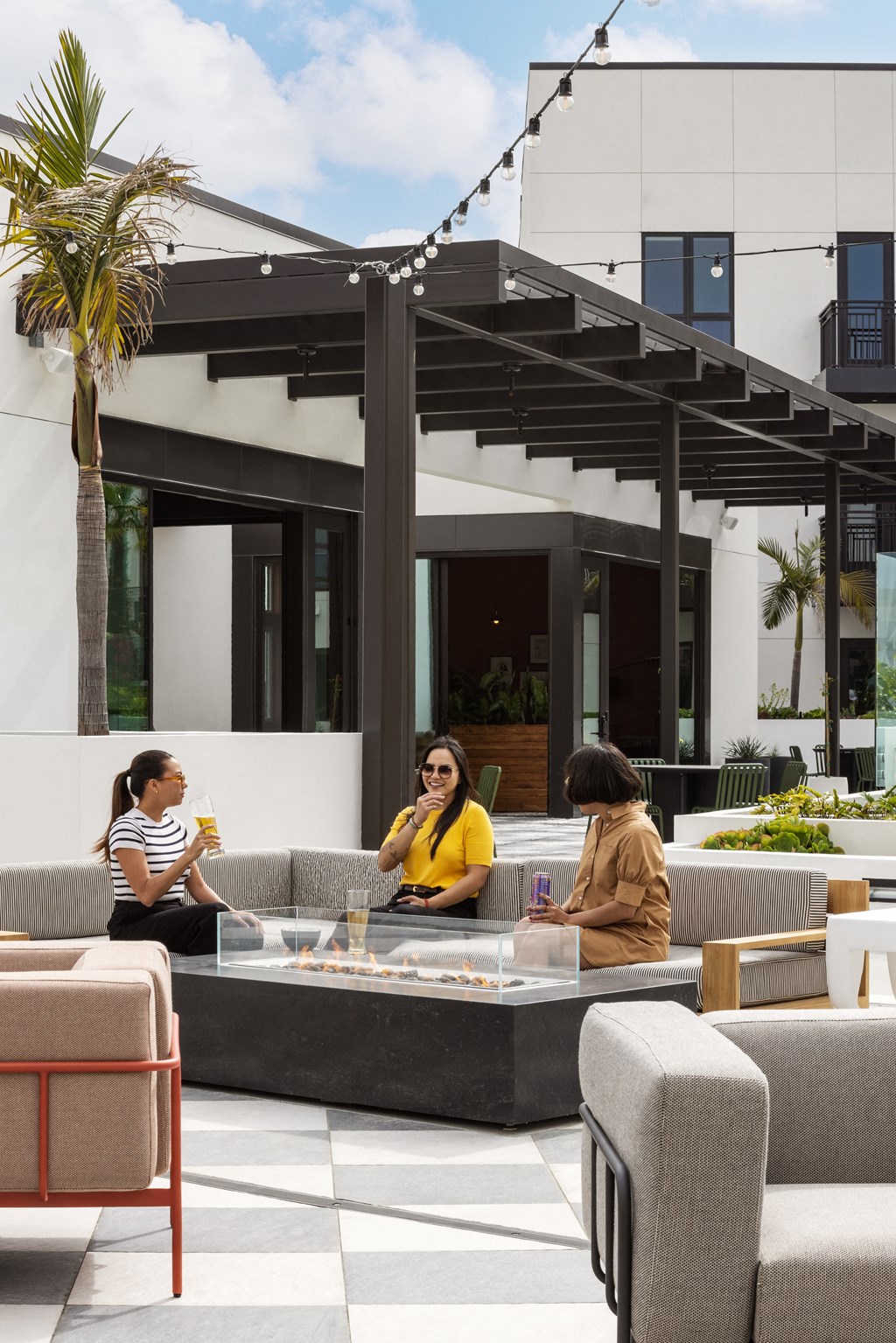 a group of people sitting around a table in a patio