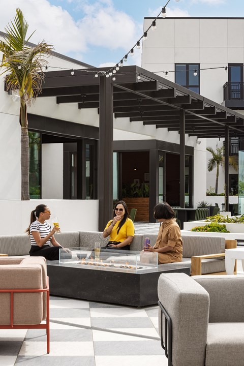 a group of people sitting around a table in a patio