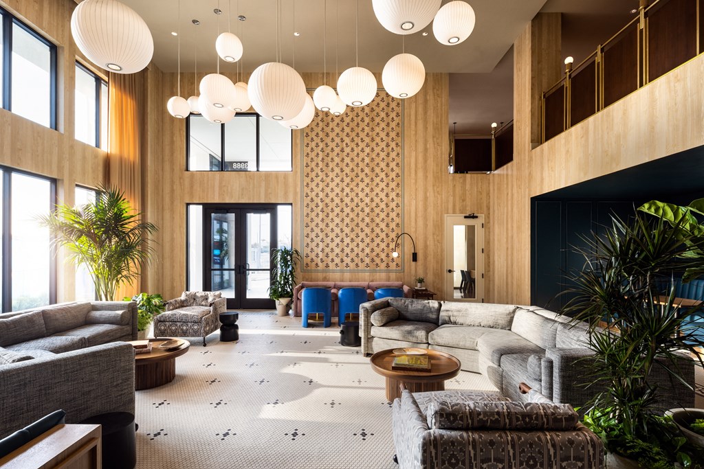 the lobby of a hotel with couches and chairs