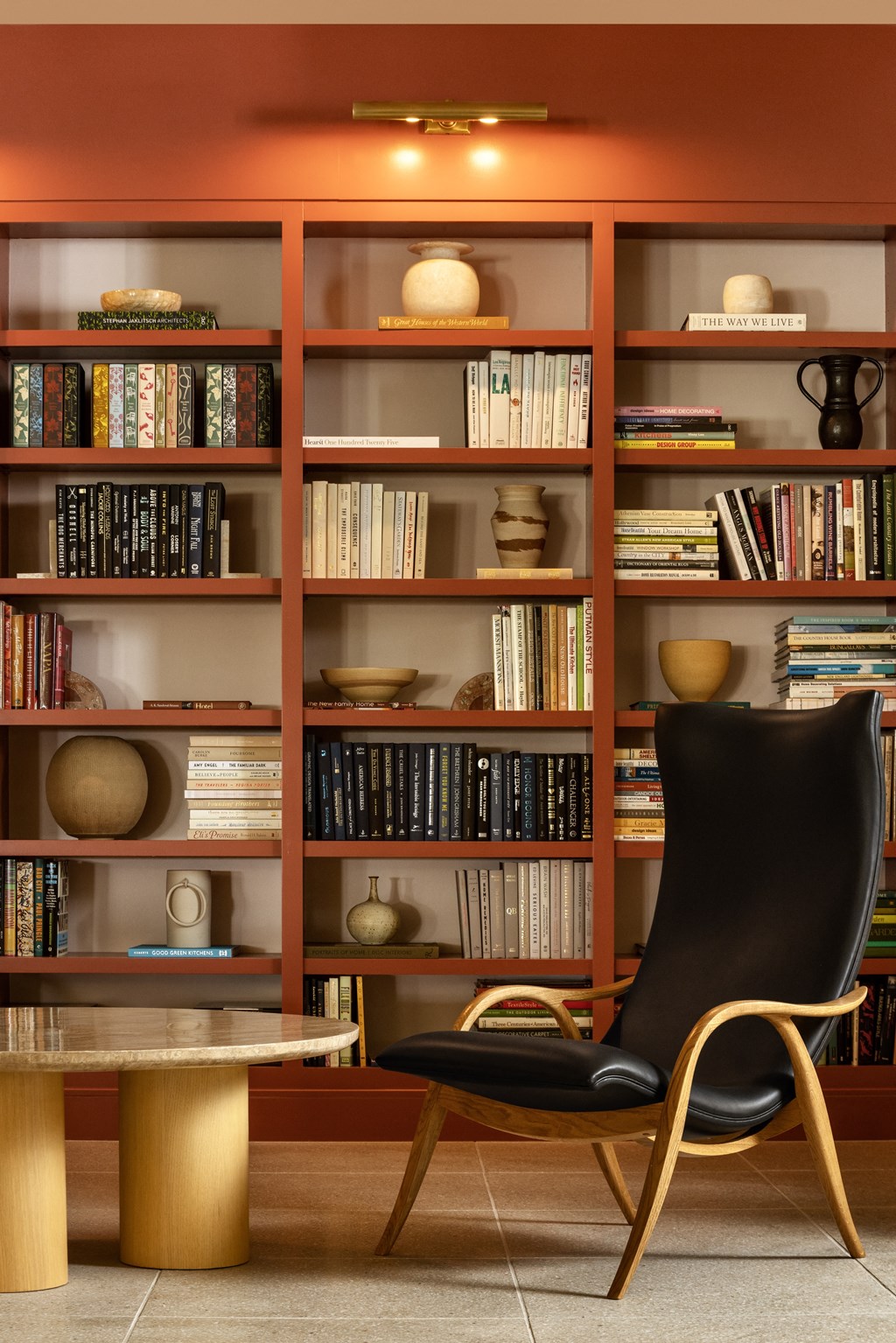 a library with bookshelves and a chair and a table