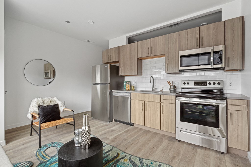 a kitchen with wooden cabinets and stainless steel appliances