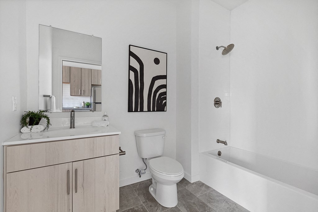a bathroom with a white sink and toilet and a white bathtub