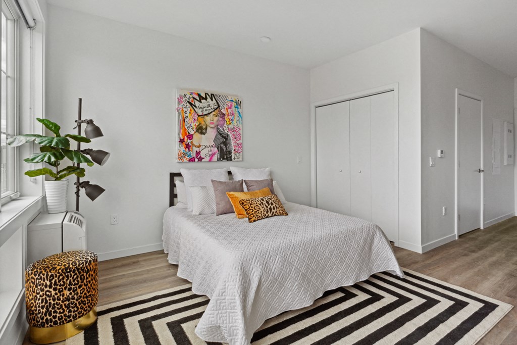 a bedroom with a bed and a window