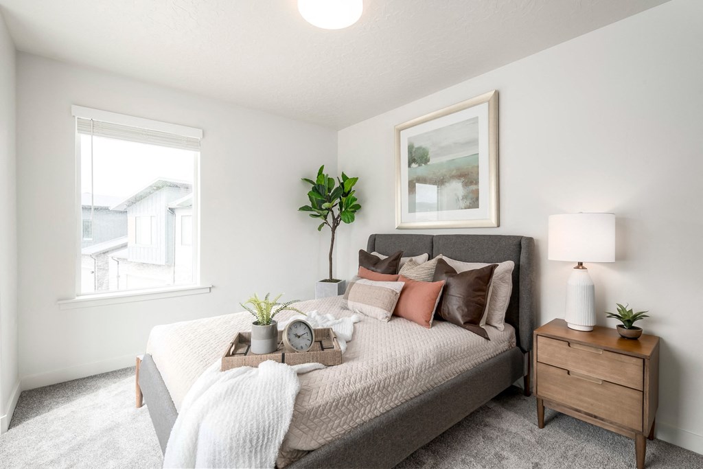 a bedroom with a couch and a window