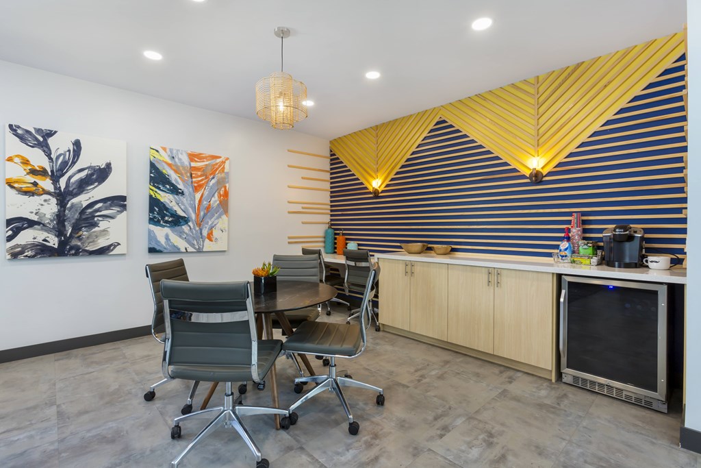 A modern kitchen with a dining table and chairs.
