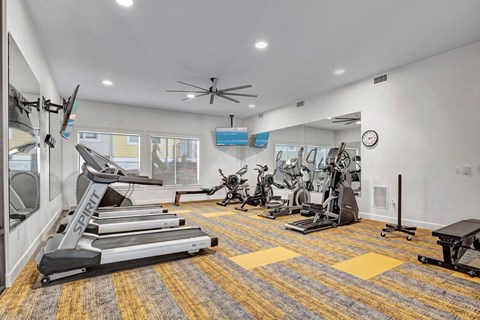 A well-equipped gym with treadmills, exercise bikes, and other fitness machines.