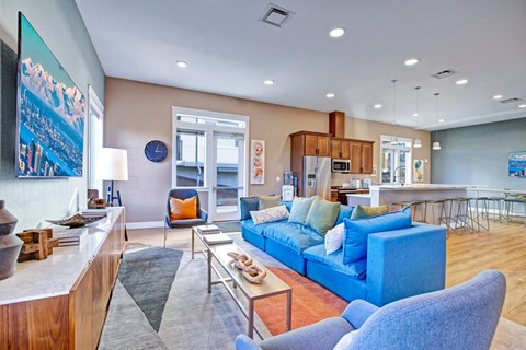 A living room with a blue couch and a wooden cabinet.