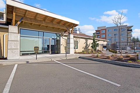 A parking lot in front of a building with a sign that says "No Parking".