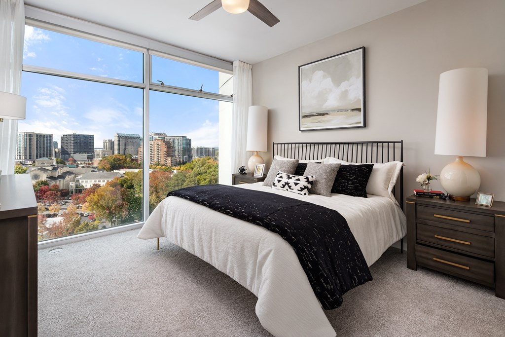 a bedroom with a bed and a view of the city