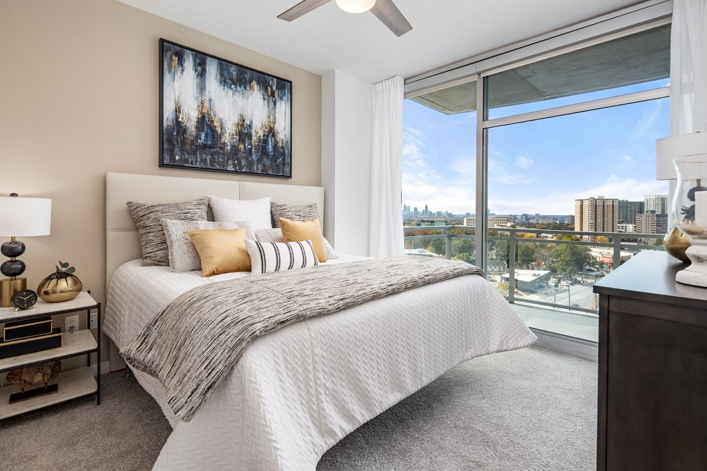 a bedroom with a bed and a view of the city