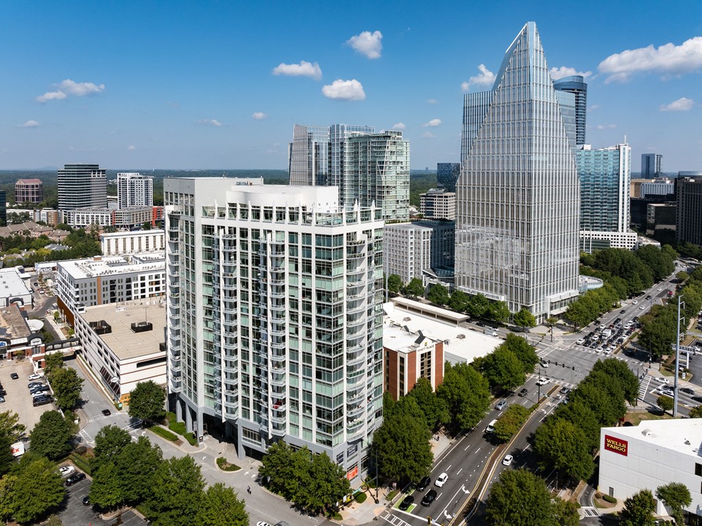 an aerial view of a city with tall buildings and trees