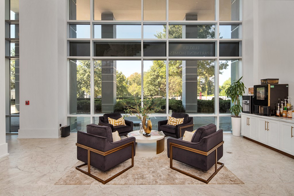 a living room filled with furniture and a large window
