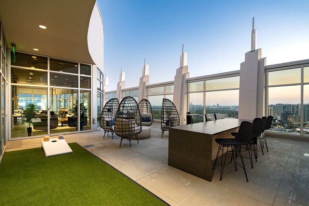 a room with a view of a city and a table and chairs in a building