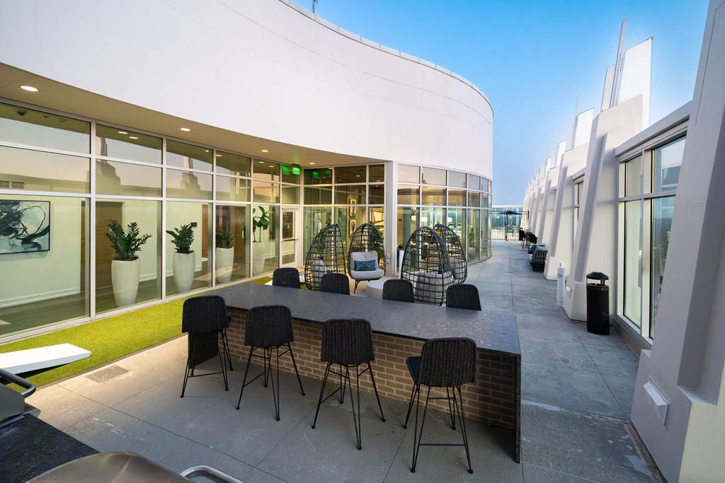 a large table with chairs outside of a building