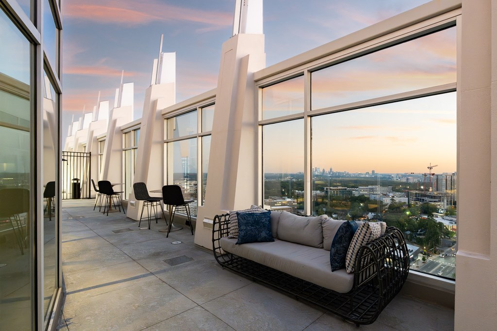 a living room with a couch and a view of a city skyline