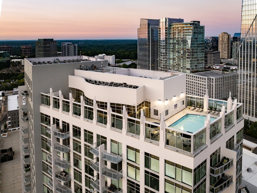 an aerial view of a skyscraper with a pool on the roof of a building
