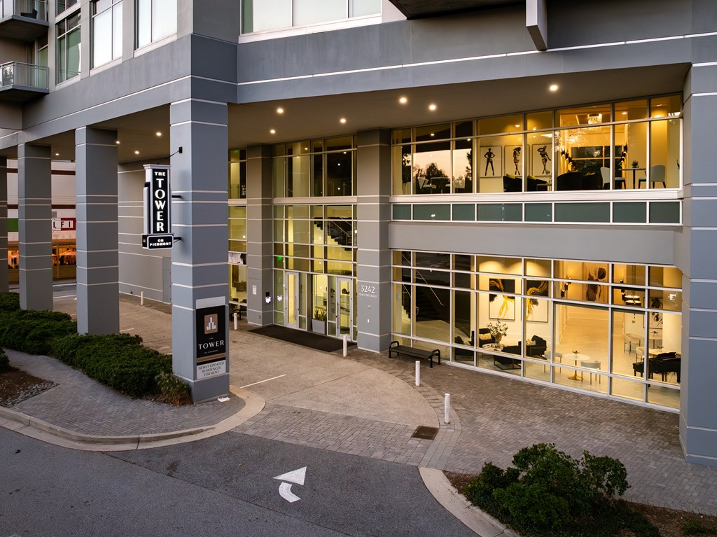 an office building with large glass windows and a courtyard