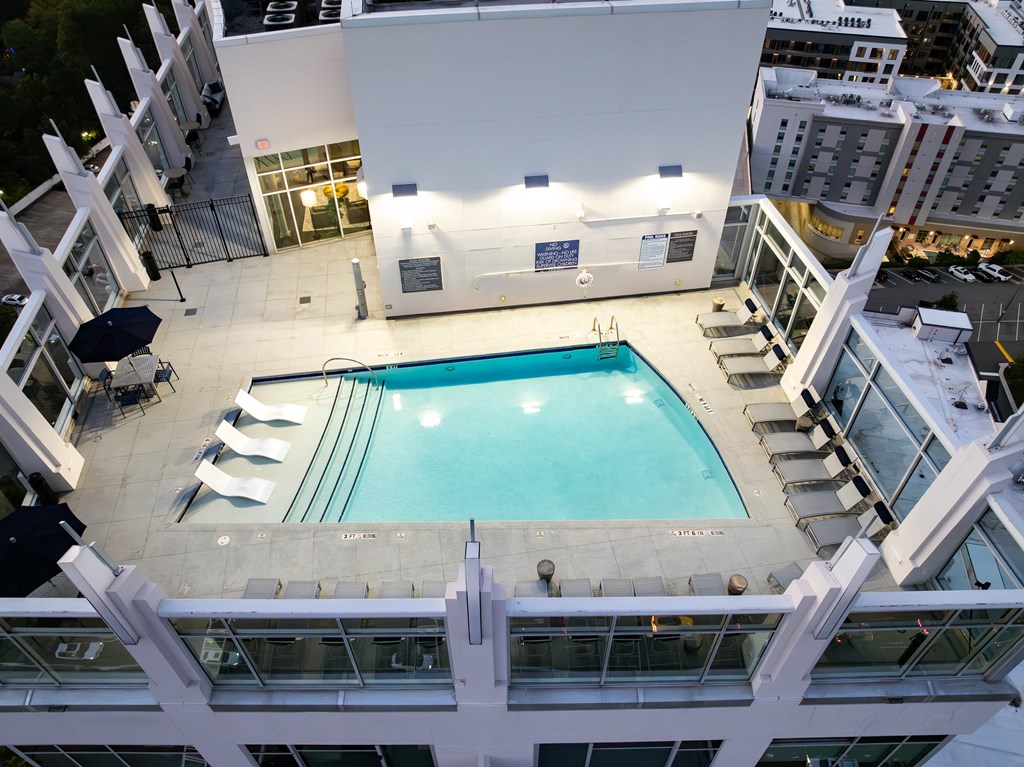 a view of the pool from the top of a building