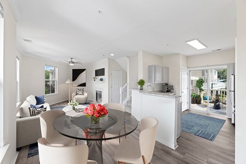 A modern dining room with a glass table and chairs.