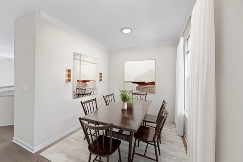 A dining room with a wooden table and chairs.