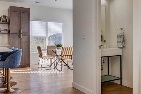 A kitchen with a table and chairs in it.
