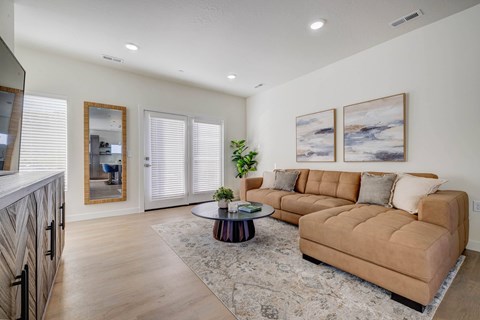 A living room with a brown couch and a coffee table.