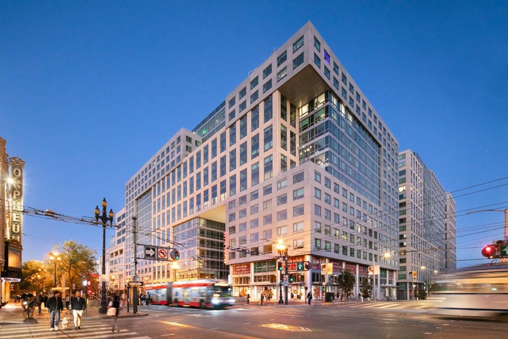 Pet Friendly Apartments in San Francisco CA - Trinity Place at 33 8th - White Building Exterior with Windows, Street view at Dusk
