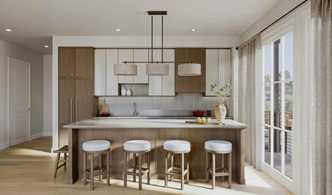 A modern kitchen with a bar area and stools.