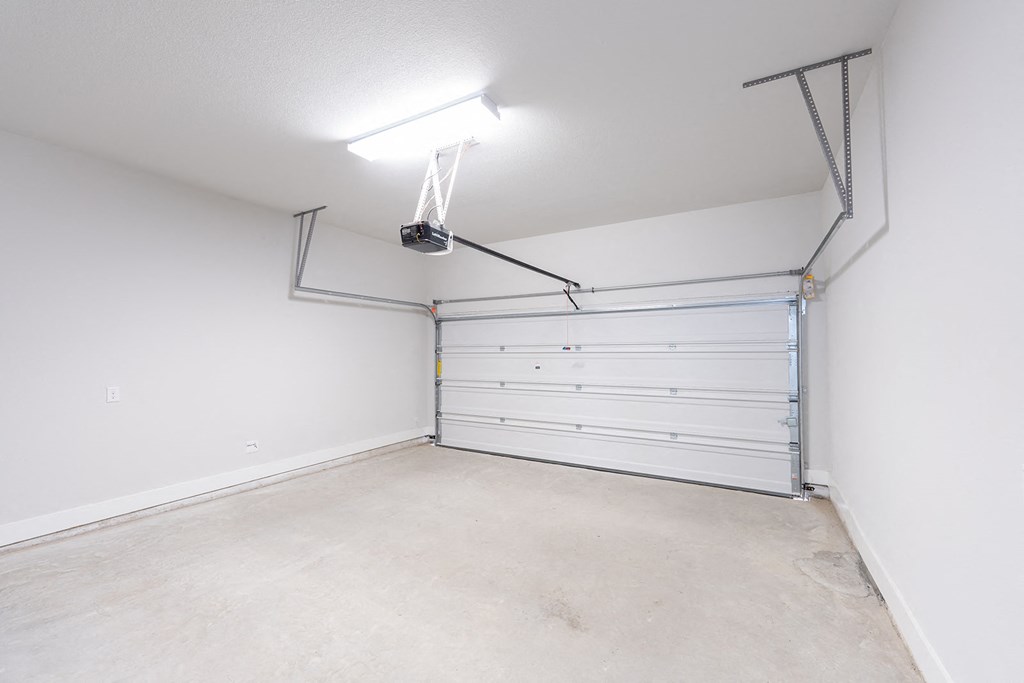 a garage with a white wall and a white garage door