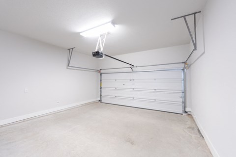a garage with a white wall and a white garage door