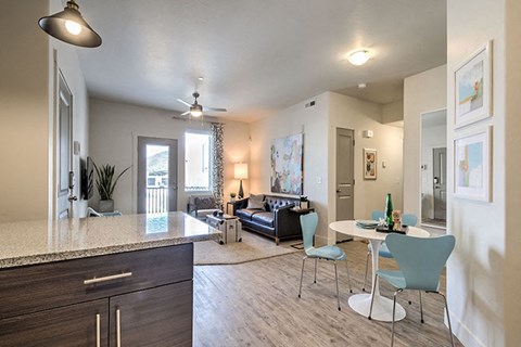 a living room and dining room with a table and chairs