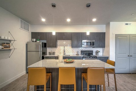 a kitchen with a marble counter top and stainless steel appliances
