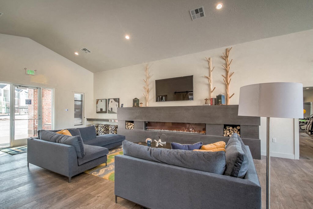 lounge area with fireplace and television
