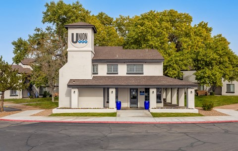 a white building with a clock tower on the corner of a street