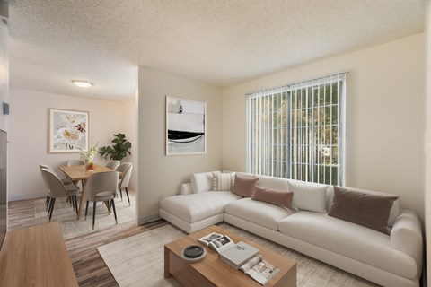 A living room with a white couch and a coffee table.
