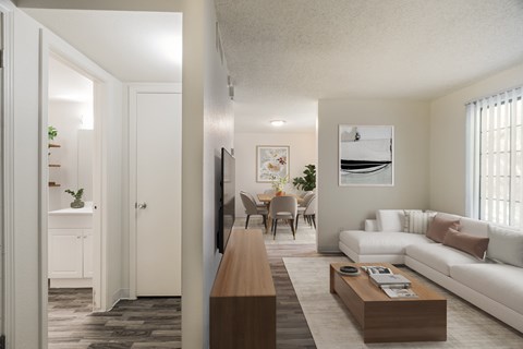 A living room with a white couch and a wooden coffee table.
