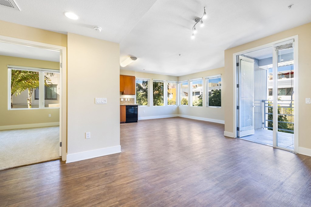 a living room with hardwood floors and white walls