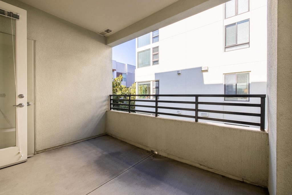 a balcony with a door and a railing