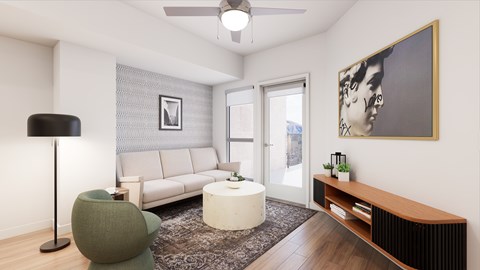 A living room with a white couch, a green chair, and a painting on the wall.