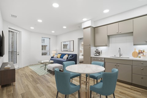 A modern kitchen with a dining table and chairs.
