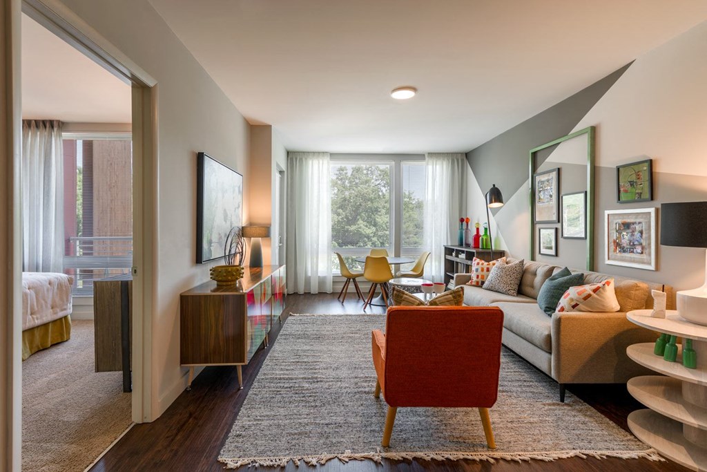 a living room filled with furniture and a large window