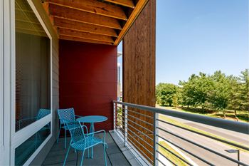 a balcony with a small table and two chairs