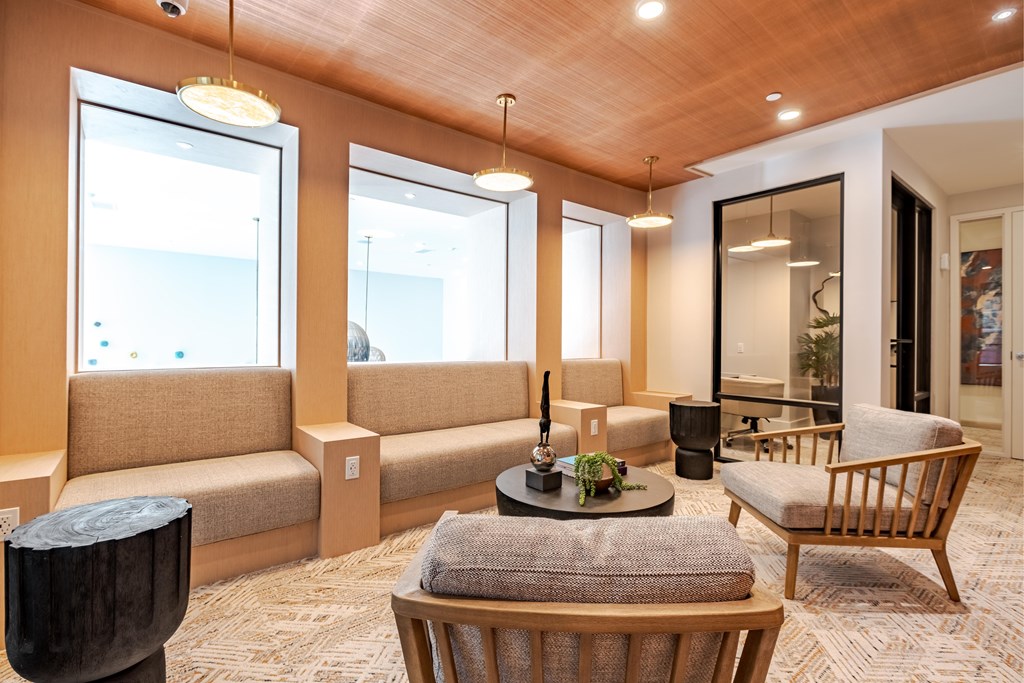 A living room with a wooden ceiling and furniture.