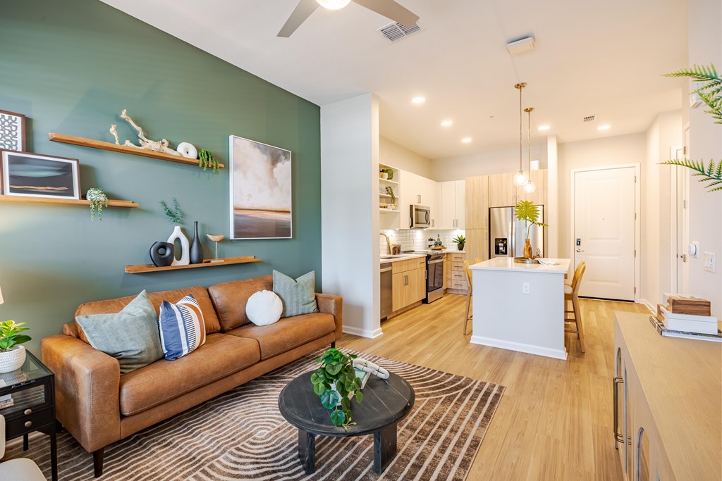 A living room with a brown couch and a coffee table.
