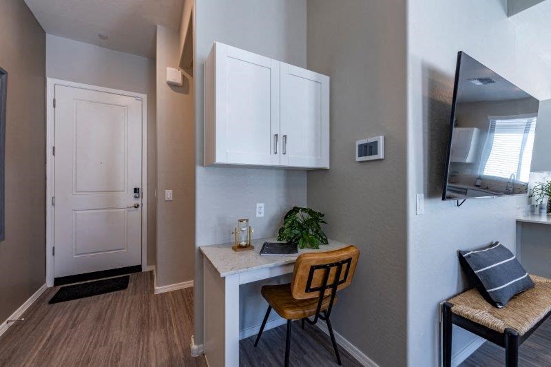 a small kitchen with a desk and a chair
