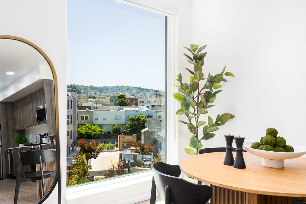a dining room with a large window and a view of the city