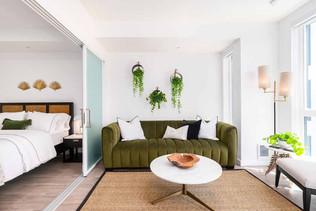 a bedroom with a bed and a couch in a room