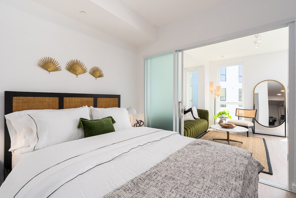 a bedroom with a bed and a large window